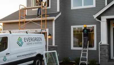 Technician performing window repair on home exterior with vinyl siding in Philadelphia, PA
